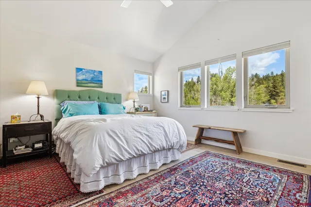 a bedroom with a bed lamp and a window