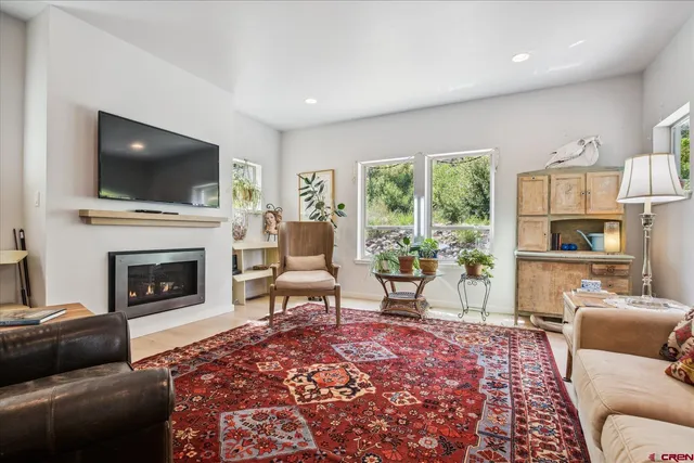 a living room with furniture and a fireplace