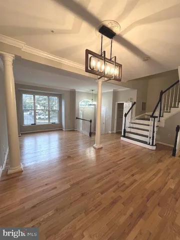 a view of a room wooden floor and windows