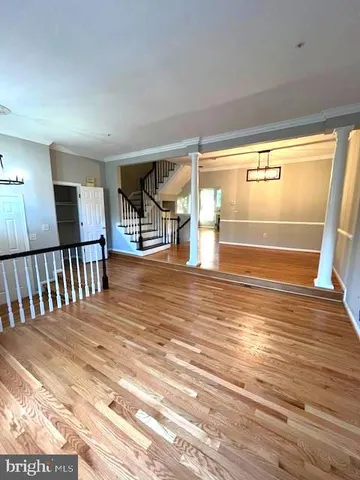 a view of a room with wooden floor and windows