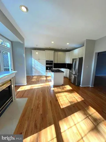 a view of kitchen with sink microwave and refrigerator