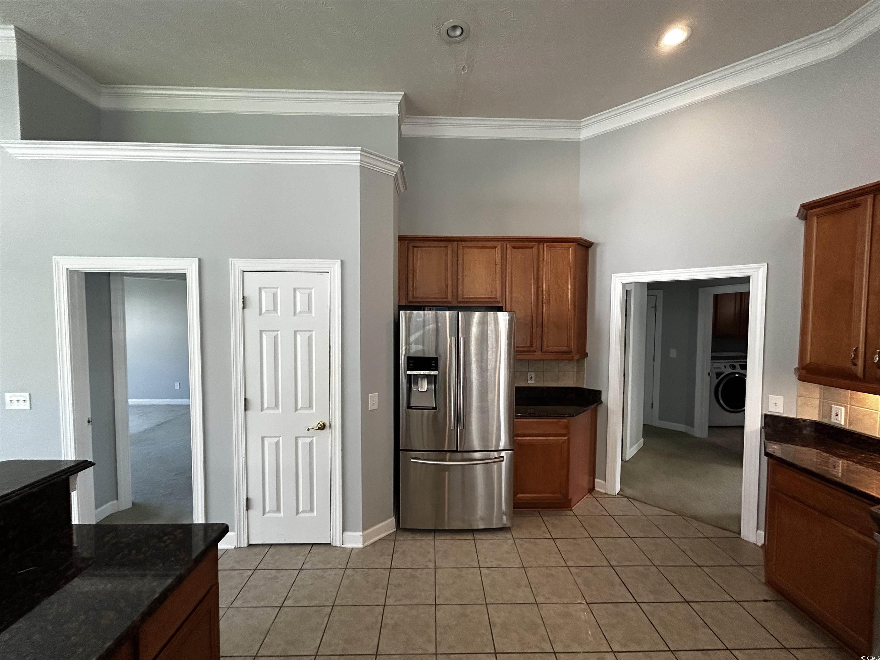 1300 Manchester Court Murrells Inlet, SC 29576 - Photo 12 of 40 Kitchen with washer / dryer, stainless steel fridg