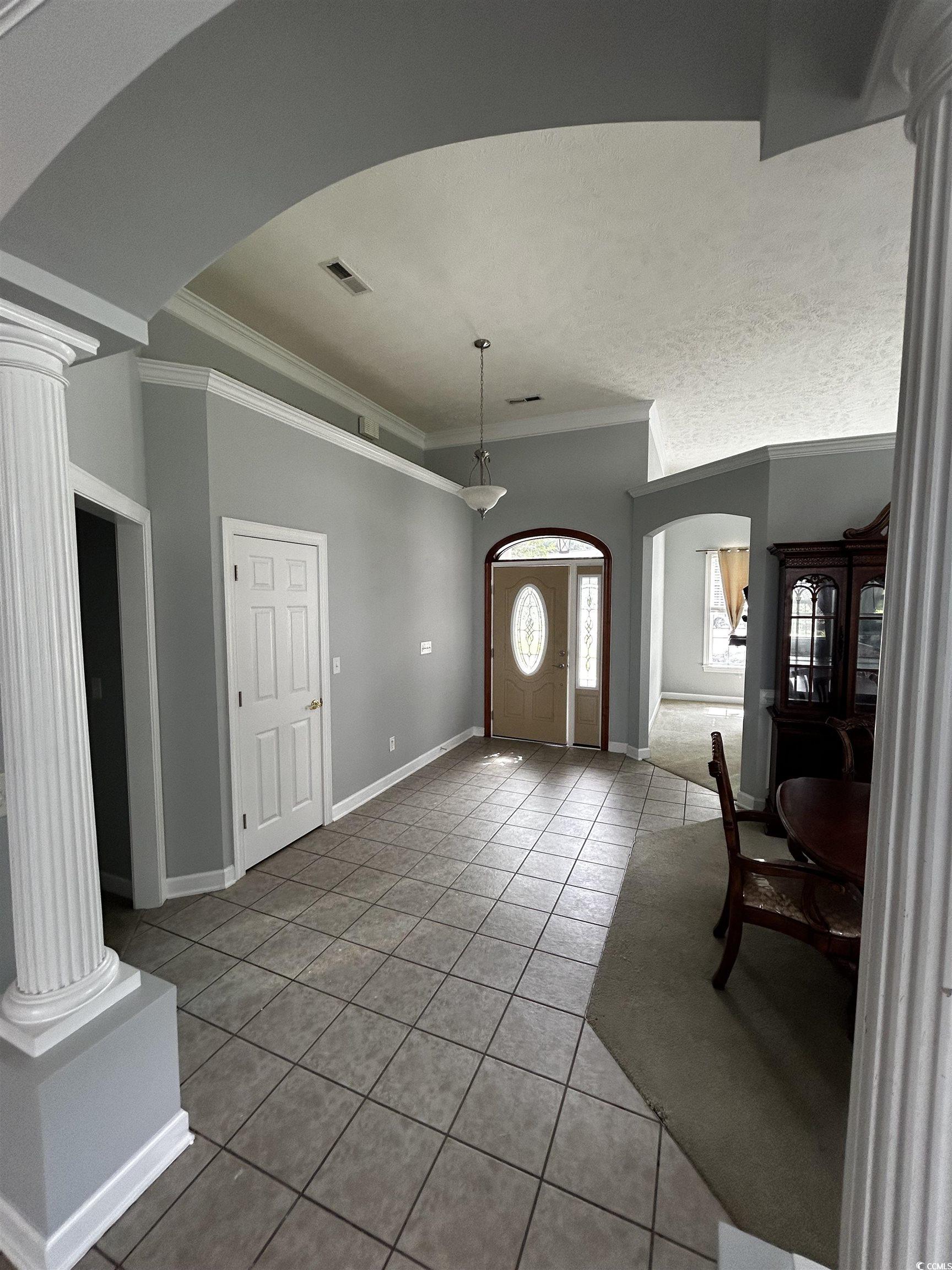 1300 Manchester Court Murrells Inlet, SC 29576 - Photo 14 of 40 Entryway featuring tile floors, crown molding, and