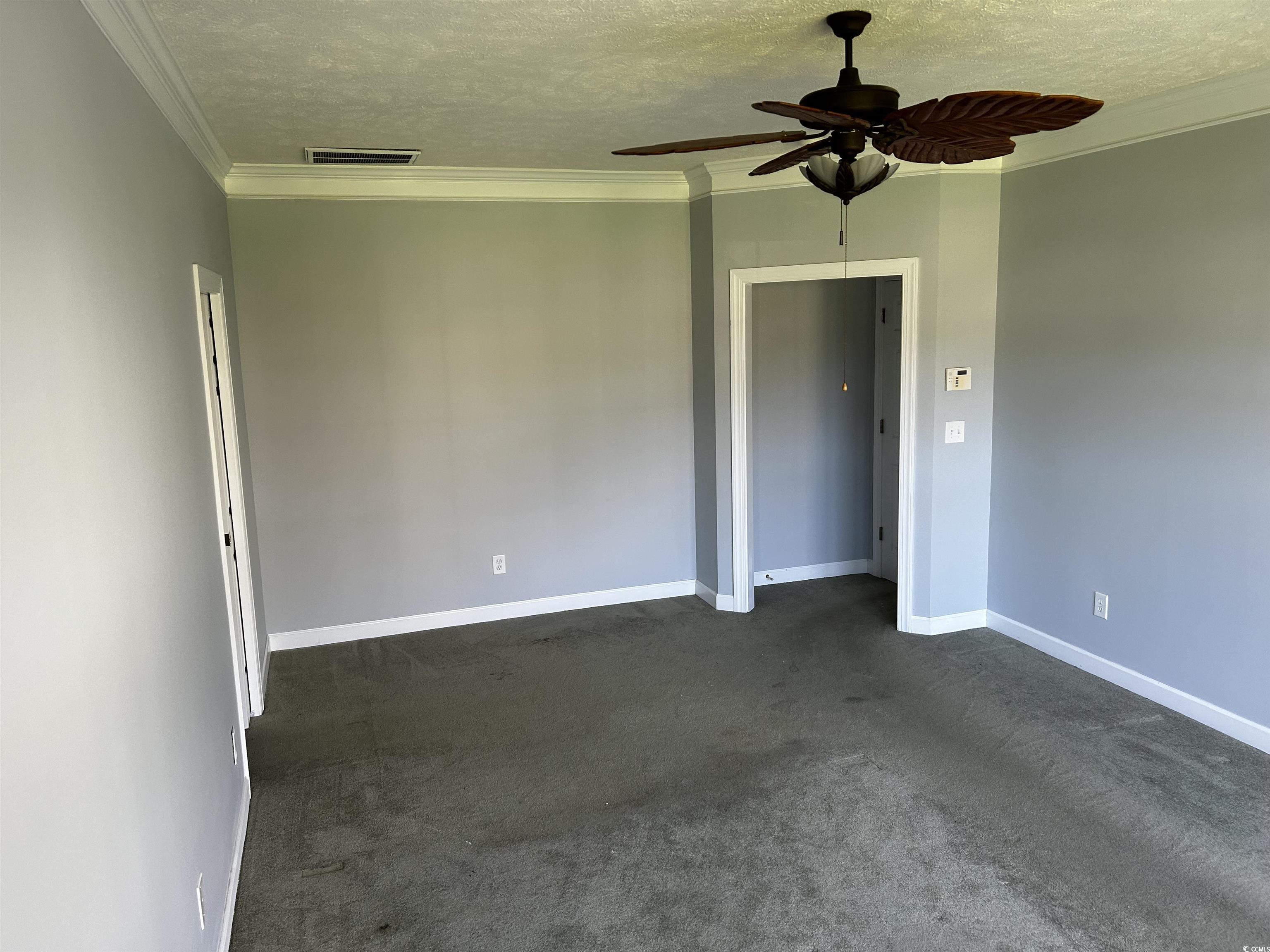 1300 Manchester Court Murrells Inlet, SC 29576 - Photo 15 of 40 Empty room featuring crown molding, a textured cei