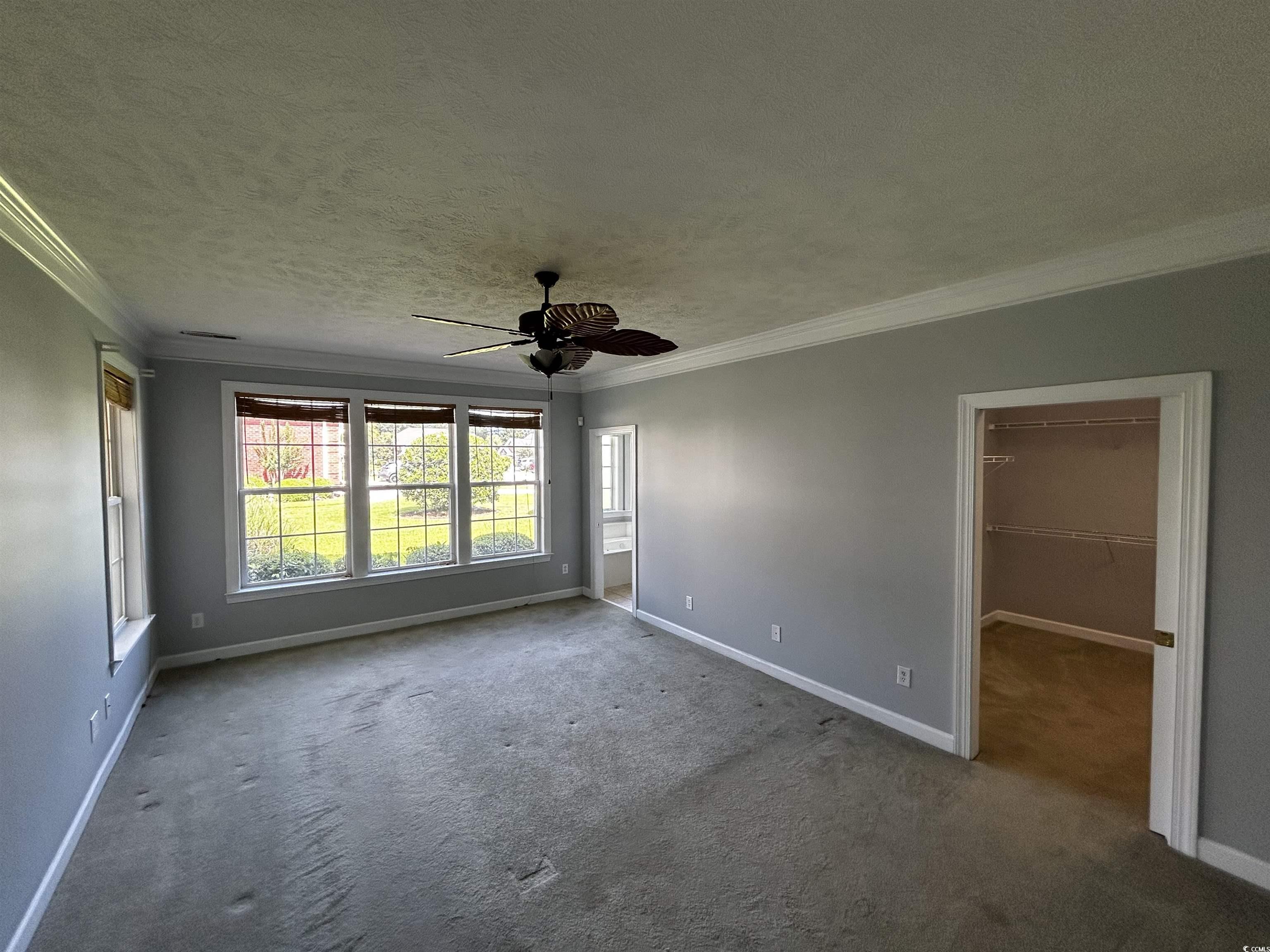 1300 Manchester Court Murrells Inlet, SC 29576 - Photo 16 of 40 Carpeted empty room with ceiling fan, a textured c