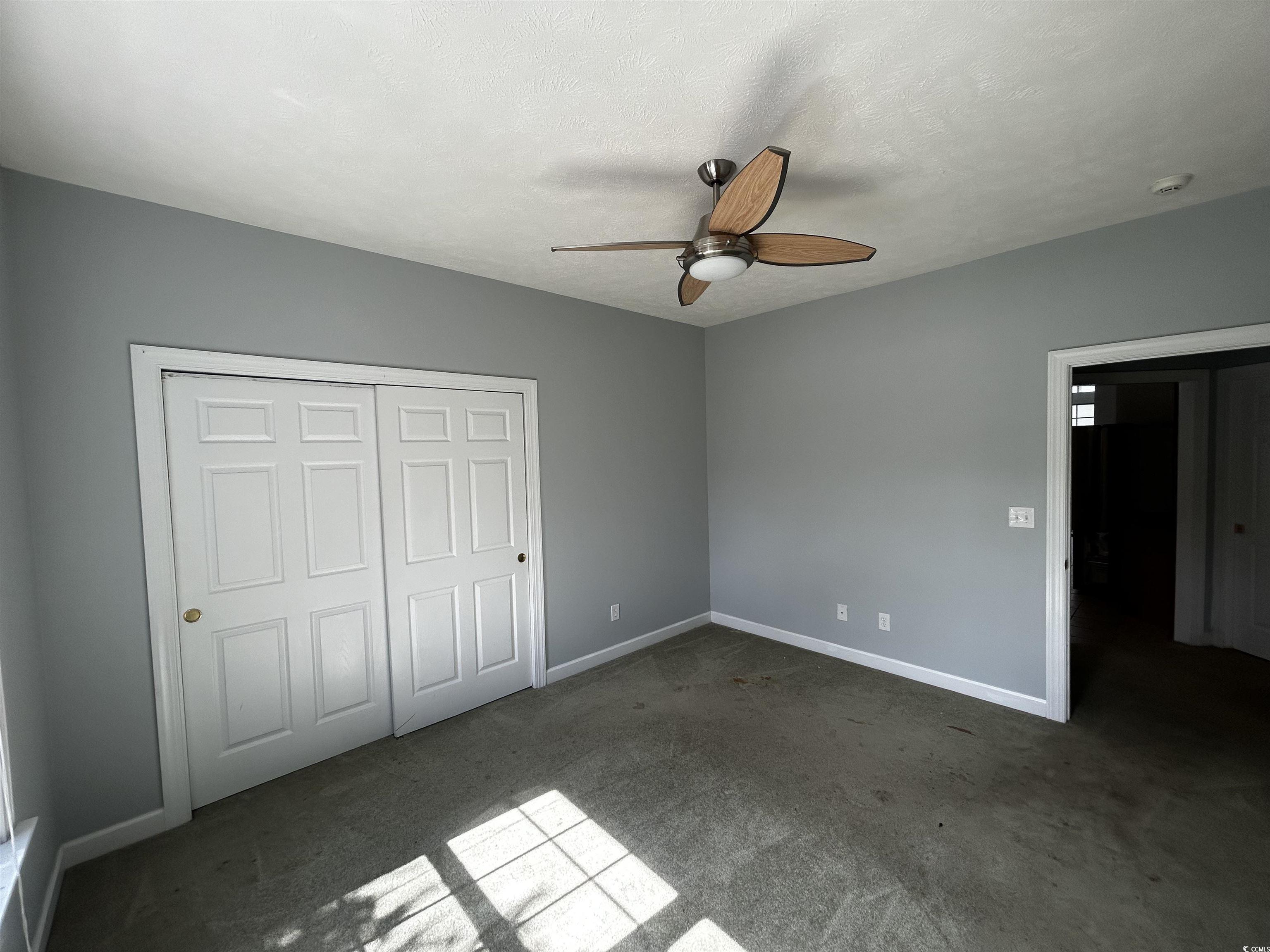 1300 Manchester Court Murrells Inlet, SC 29576 - Photo 31 of 40 Unfurnished bedroom with ceiling fan, a closet, an