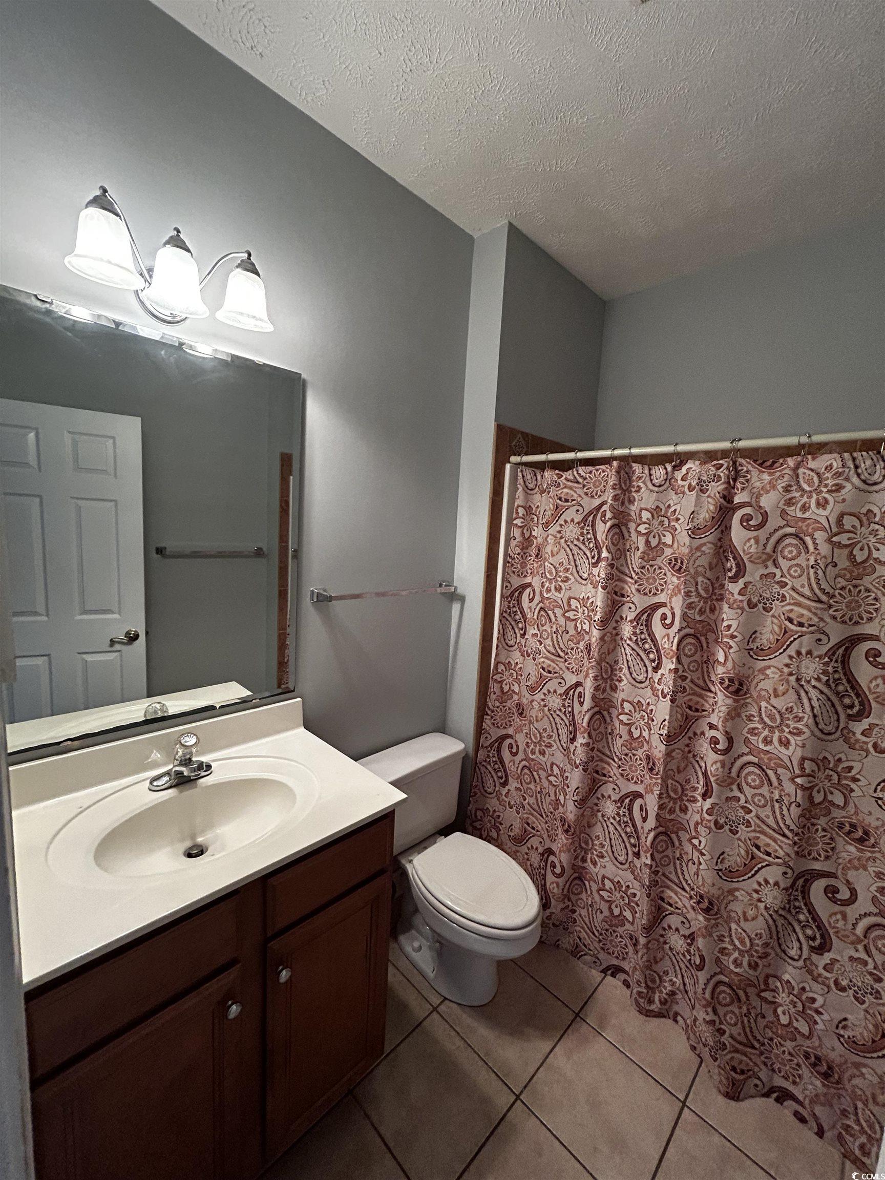 1300 Manchester Court Murrells Inlet, SC 29576 - Photo 33 of 40 Bathroom with tile flooring, oversized vanity, toi