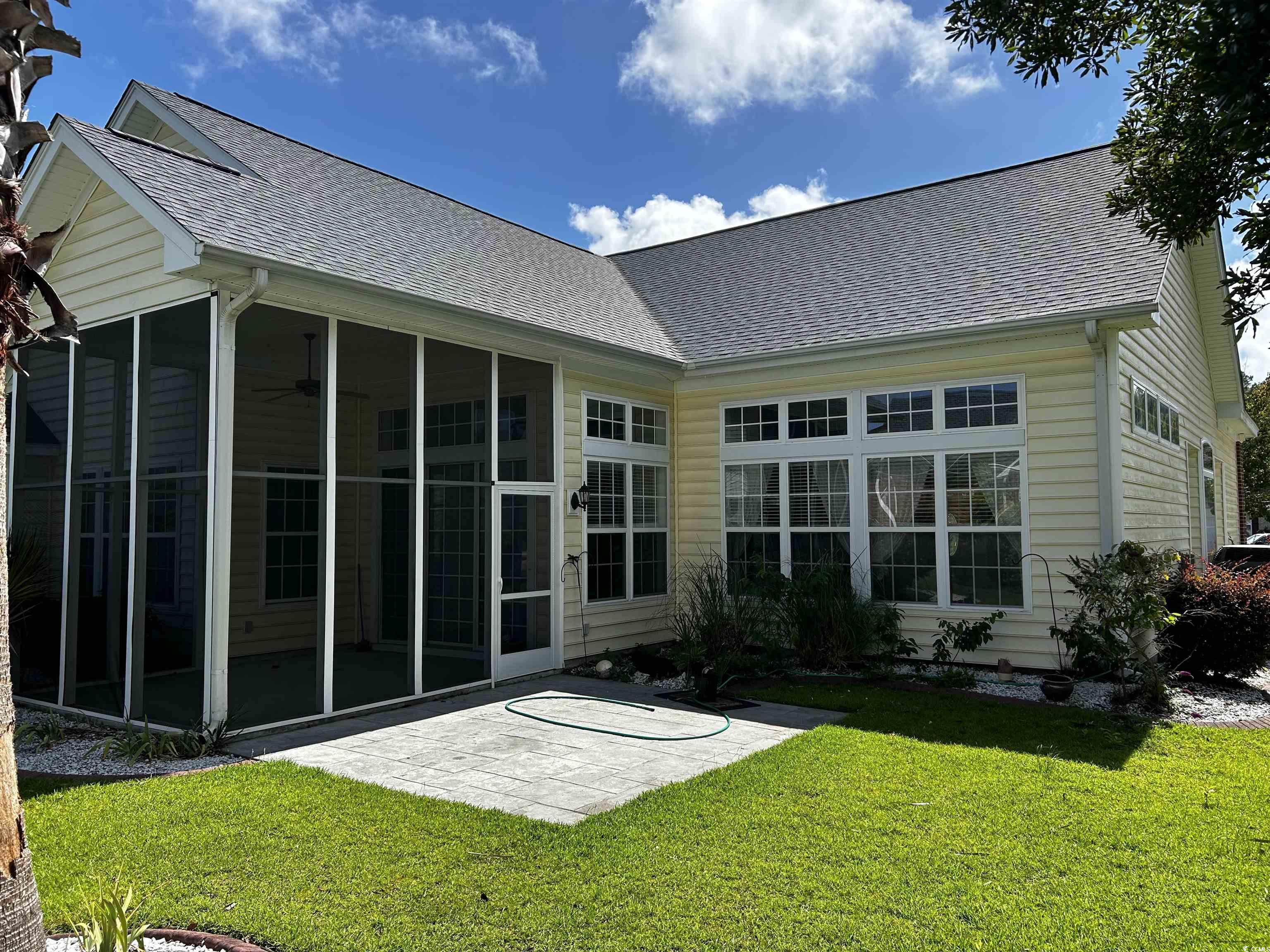 1300 Manchester Court Murrells Inlet, SC 29576 - Photo 7 of 40 Rear view of house featuring a sunroom and a lawn