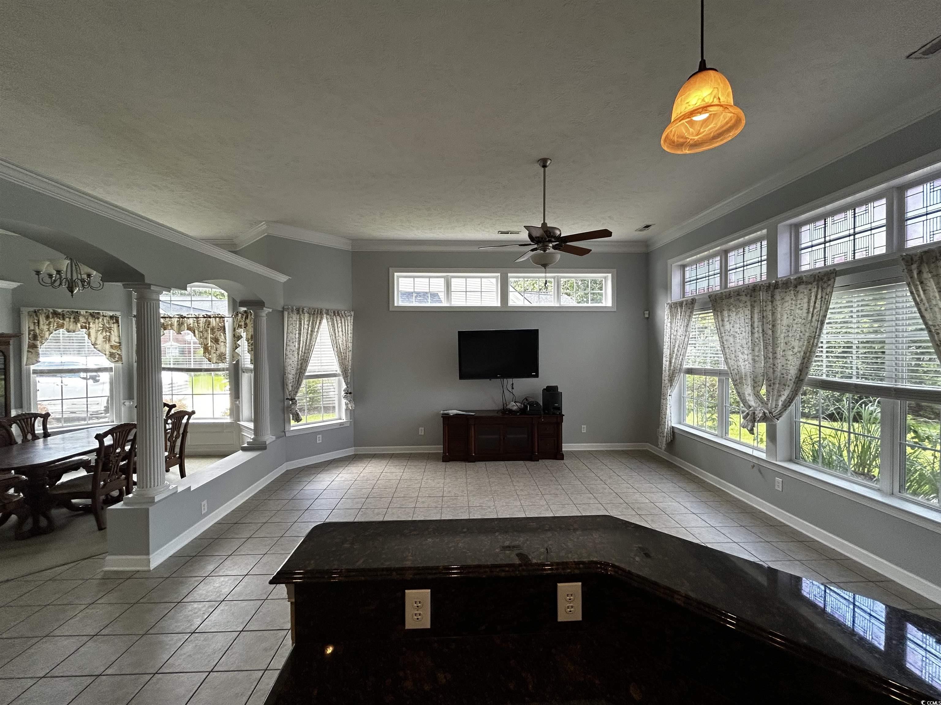 1300 Manchester Court Murrells Inlet, SC 29576 - Photo 10 of 40 Unfurnished living room with crown molding, a text