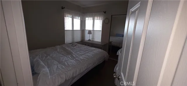 a bedroom with a bed and glass door