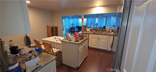 a kitchen with sink refrigerator and cabinets