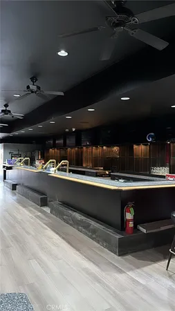 a living room with stainless steel appliances kitchen island granite countertop lots of clutter