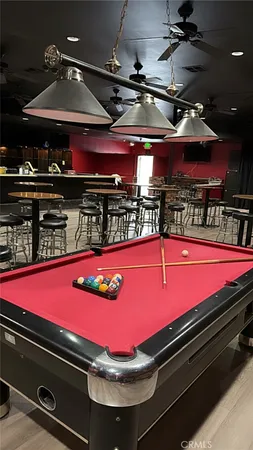 a room with pool table table and chairs