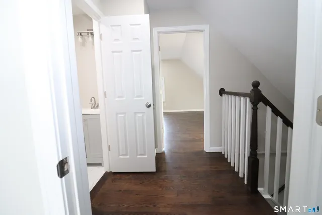 a view of a hallway with wooden floor and entryway