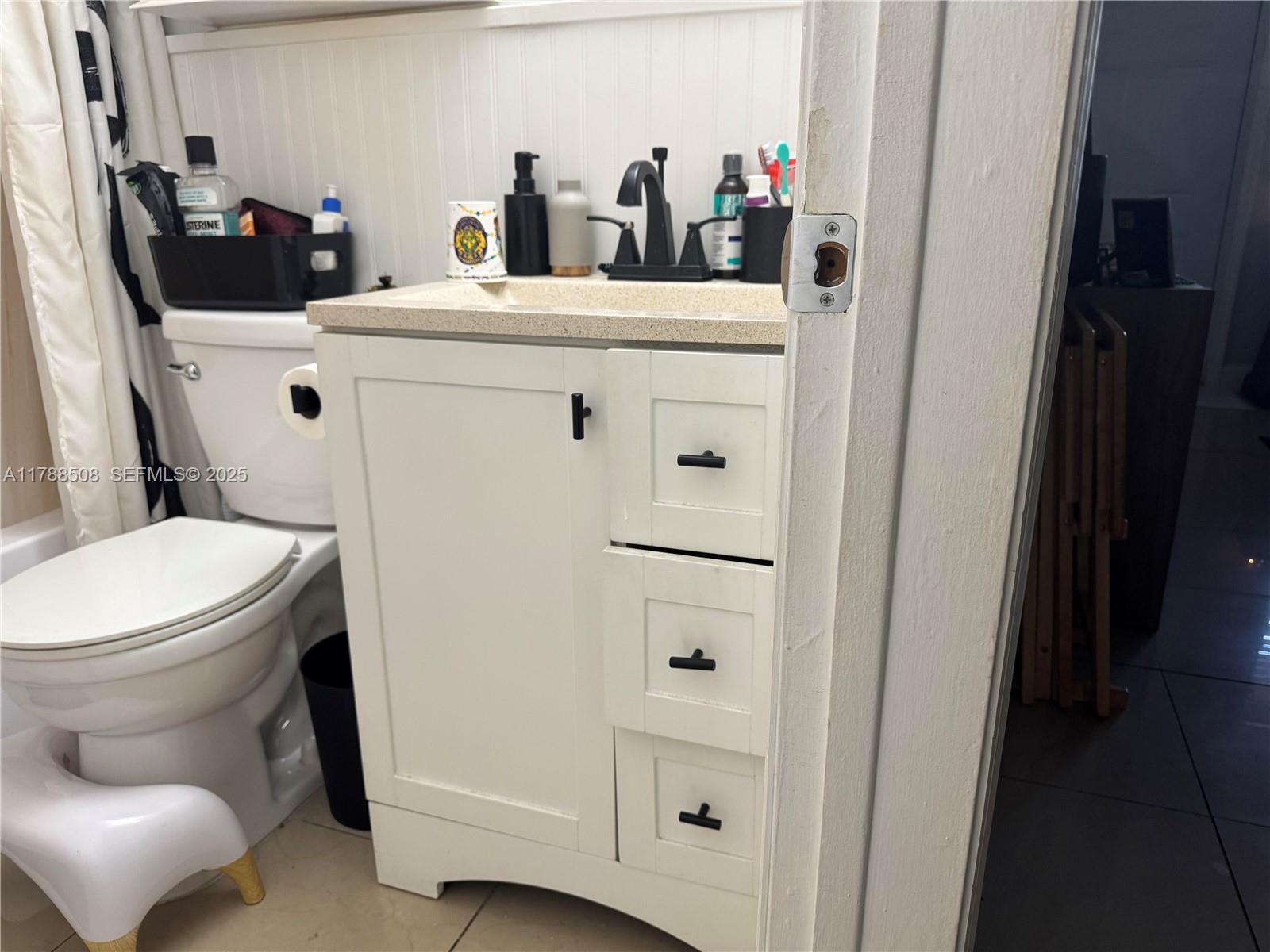 2631 Southwest 13th Avenue Fort Lauderdale, FL 33315 - Photo 12 of 24 a bathroom with a toilet a sink and a mirror
