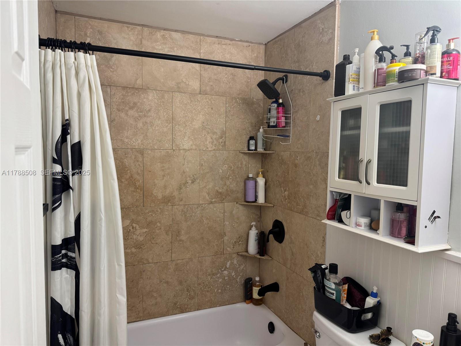 2631 Southwest 13th Avenue Fort Lauderdale, FL 33315 - Photo 13 of 24 a bathroom with a bathtub and a shower