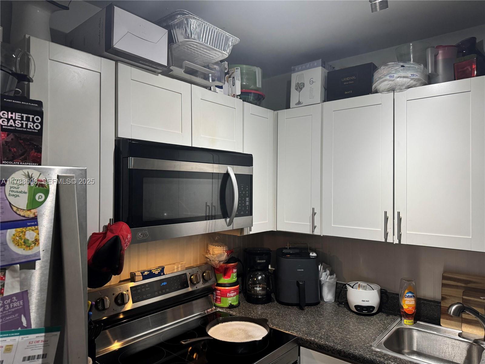2631 Southwest 13th Avenue Fort Lauderdale, FL 33315 - Photo 15 of 24 a kitchen with stainless steel appliances a cabinets and a wooden floor