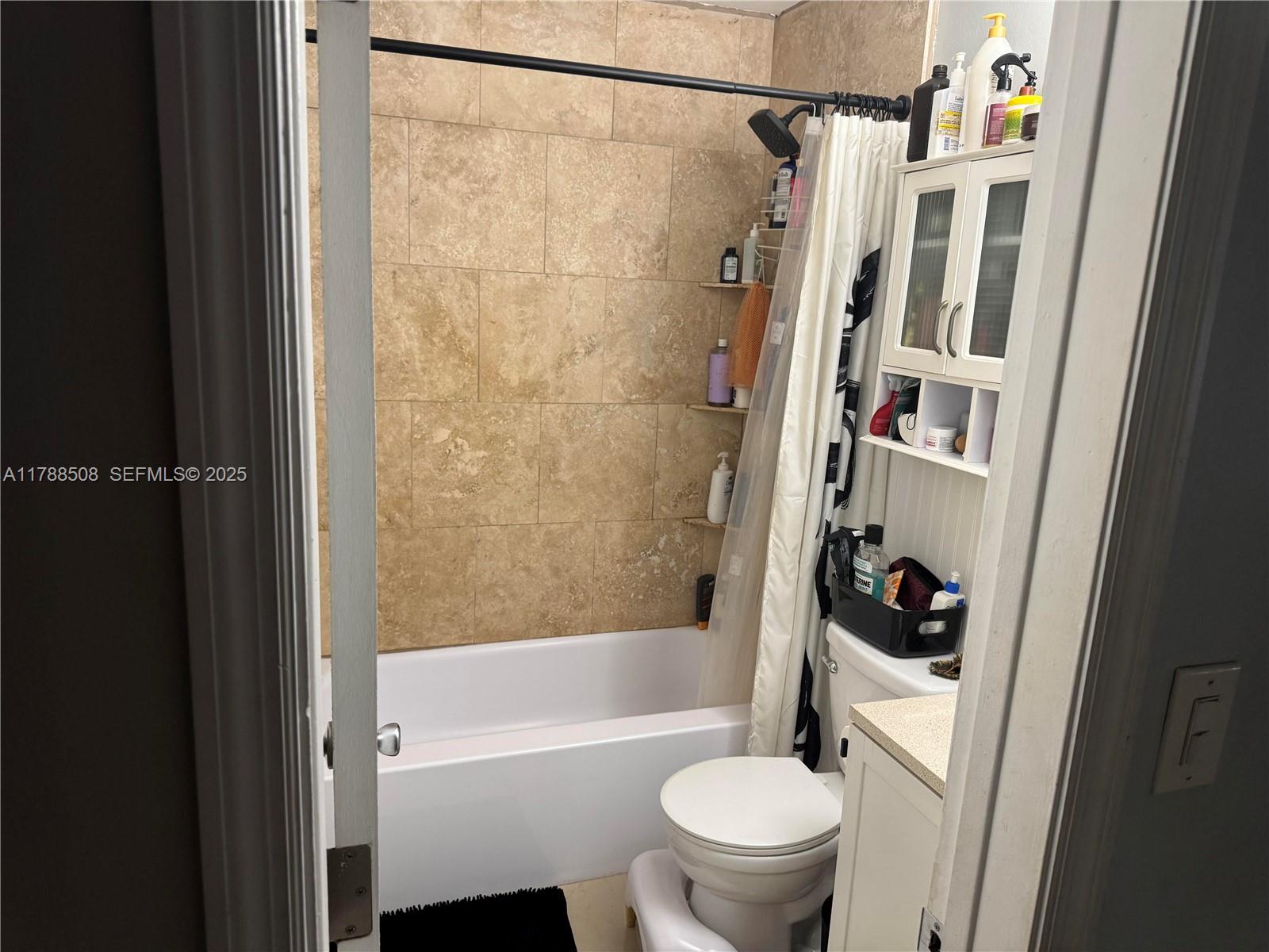 2631 Southwest 13th Avenue Fort Lauderdale, FL 33315 - Photo 16 of 24 a bathroom with a shower a toilet and a bathtub
