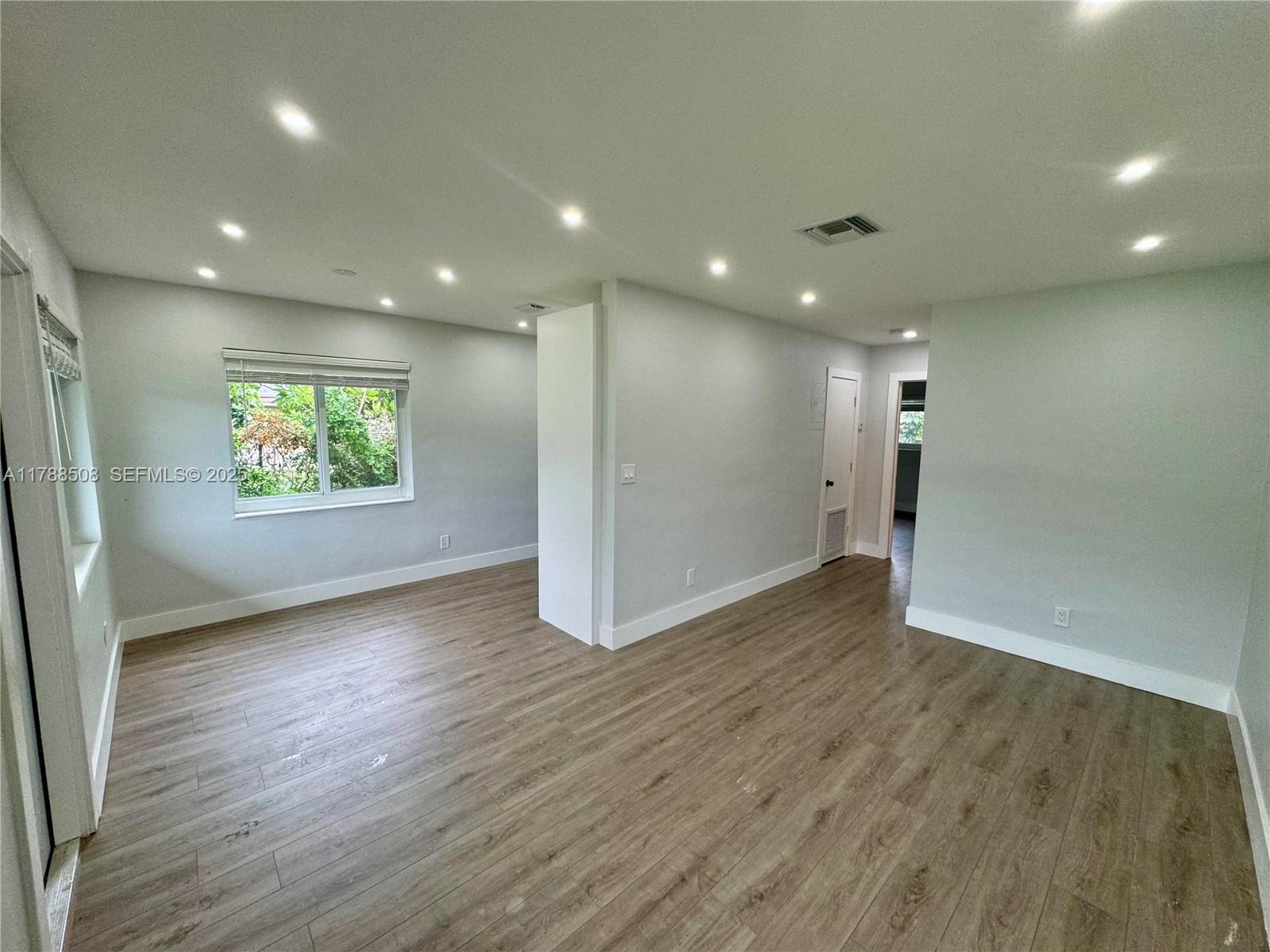2631 Southwest 13th Avenue Fort Lauderdale, FL 33315 - Photo 2 of 24 an empty room with wooden floor and windows