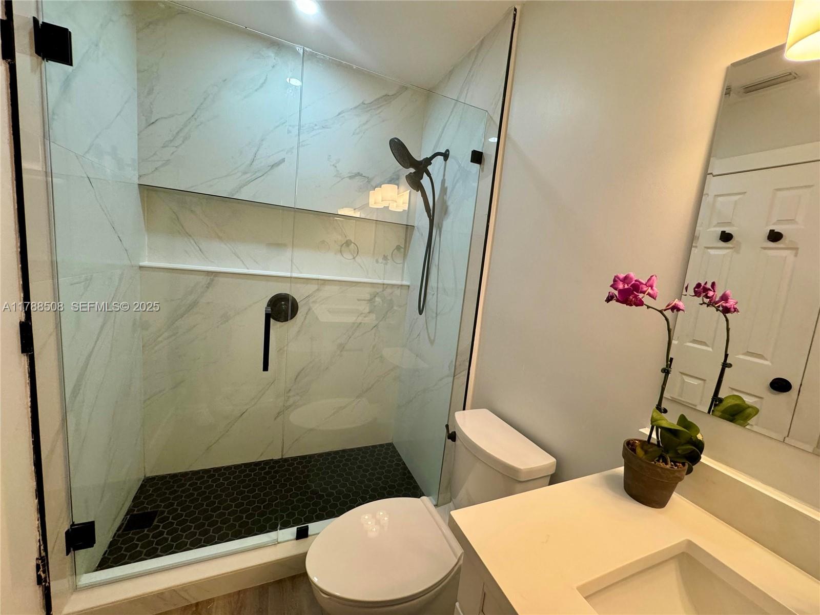 2631 Southwest 13th Avenue Fort Lauderdale, FL 33315 - Photo 3 of 24 a bathroom with a sink and a toilet