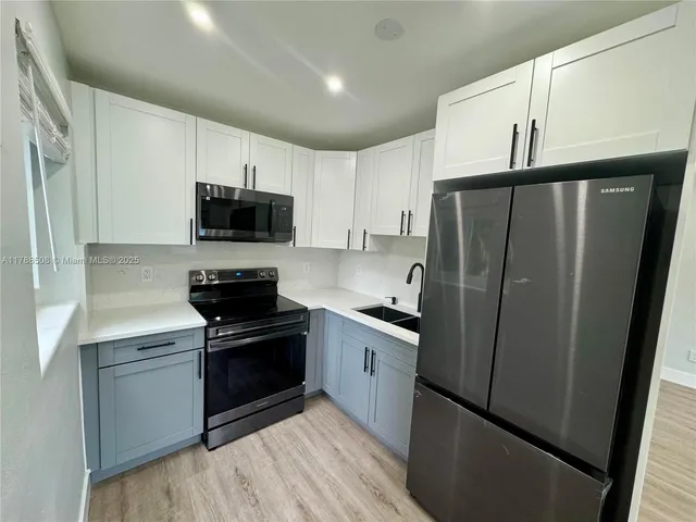 a kitchen with stainless steel appliances a refrigerator stove and sink