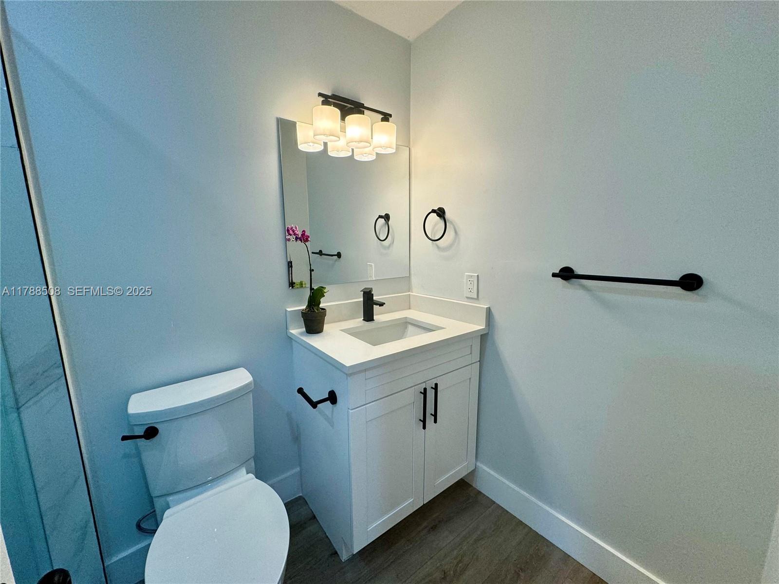 2631 Southwest 13th Avenue Fort Lauderdale, FL 33315 - Photo 7 of 24 a bathroom with a sink mirror vanity and toilet