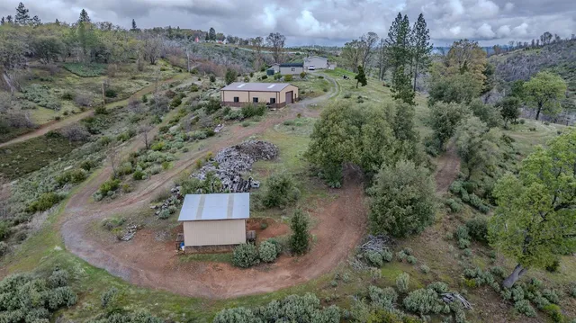 a kitchen with granite countertop a refrigerator sink and cabinets