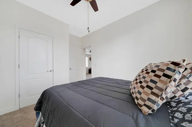 a view of a porch with wooden floor and iron stairs