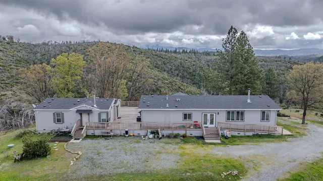 an aerial view of a house with a yard