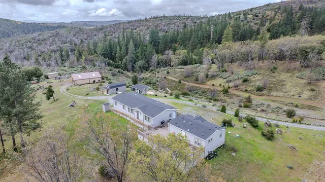 an aerial view of a house with a yard