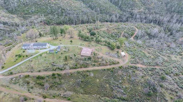 an aerial view of a house with a yard