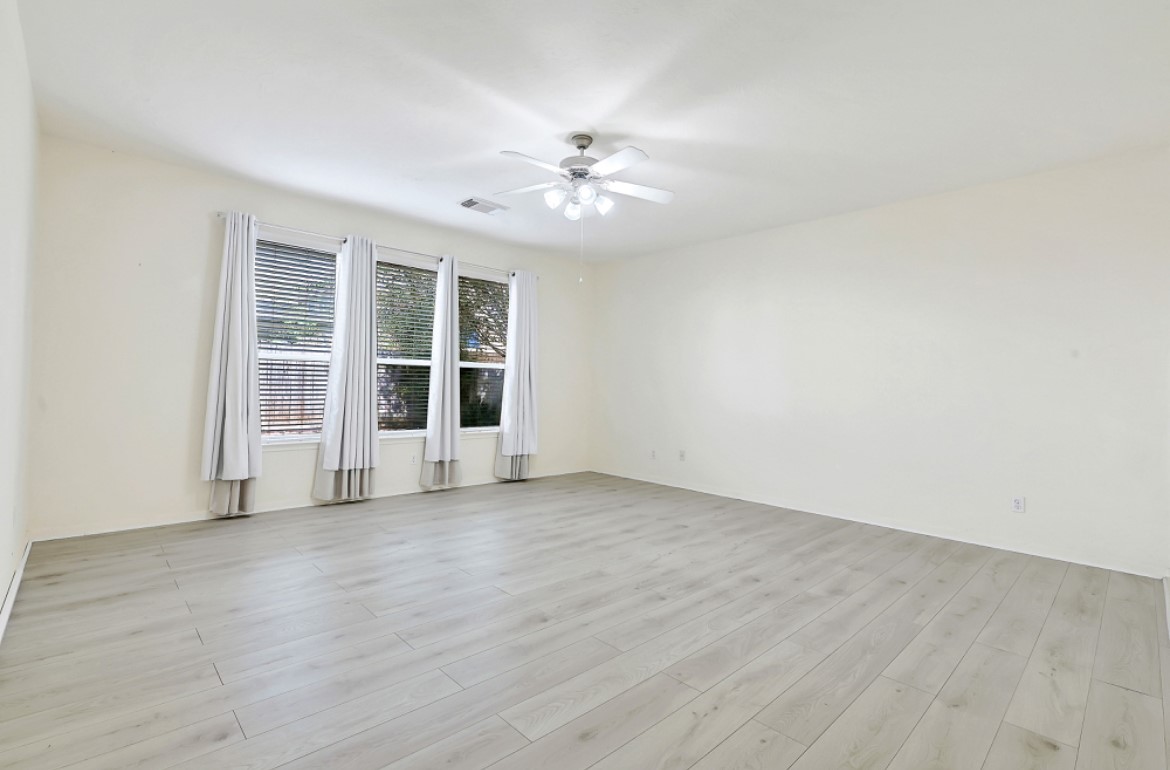 3306 Colleville Sur Mer Lane Spring, TX 77388 - Photo 16 of 40 an empty room with wooden floor fan and windows