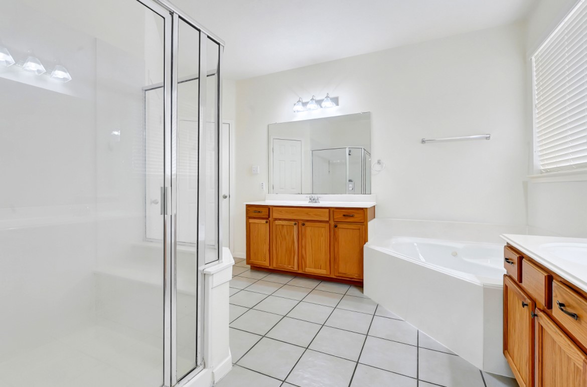 3306 Colleville Sur Mer Lane Spring, TX 77388 - Photo 18 of 40 a bathroom with a bathtub sink and mirror