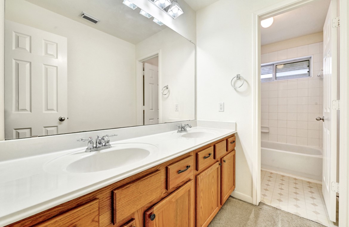 3306 Colleville Sur Mer Lane Spring, TX 77388 - Photo 33 of 40 a bathroom with a double vanity sink a mirror and a shower