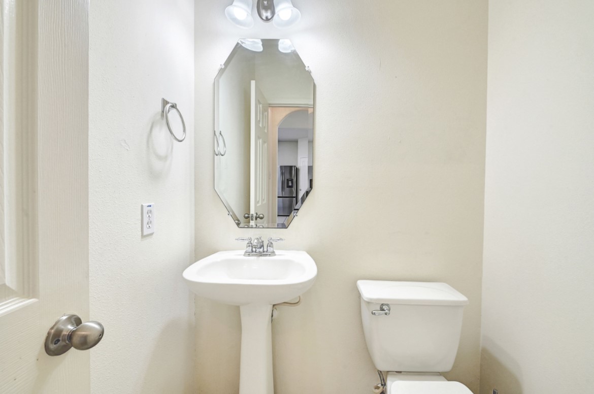3306 Colleville Sur Mer Lane Spring, TX 77388 - Photo 9 of 40 a bathroom with a toilet sink and mirror