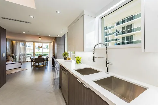 a kitchen with a sink a table and chairs