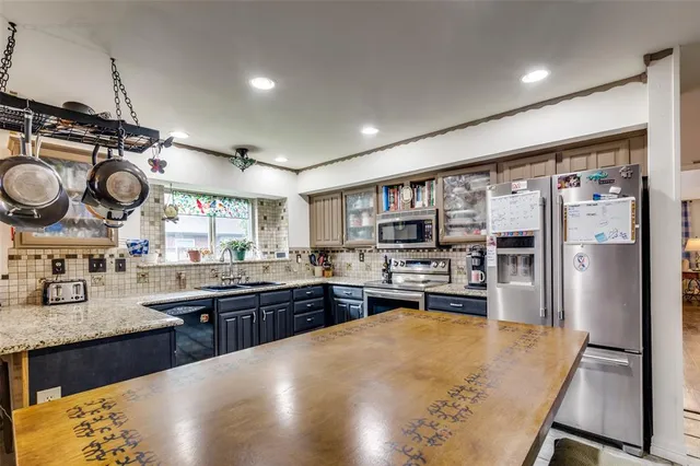 a kitchen with lots of counter space and stainless steel appliances