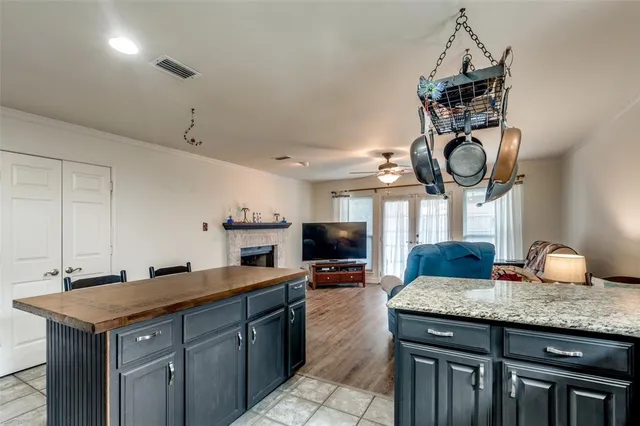 a kitchen with a counter space a sink and cabinets
