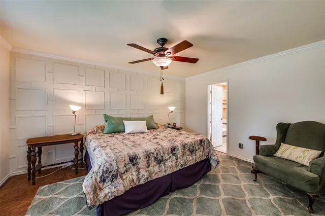 a bedroom with a bed a couch and a potted plant