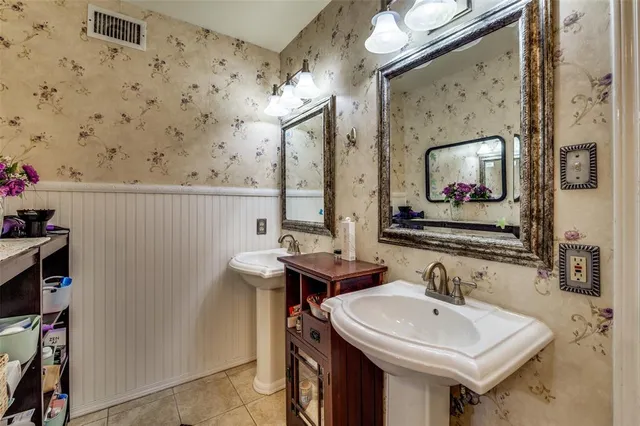 a bathroom with a sink mirror and vanity
