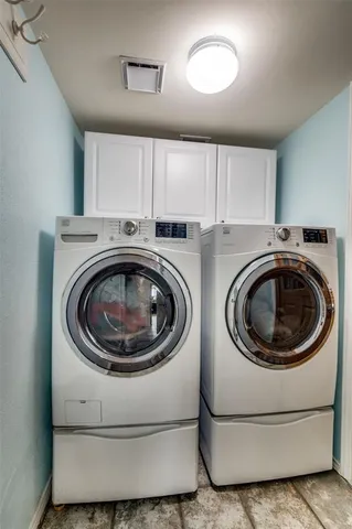 a utility room with sink dryer and washer