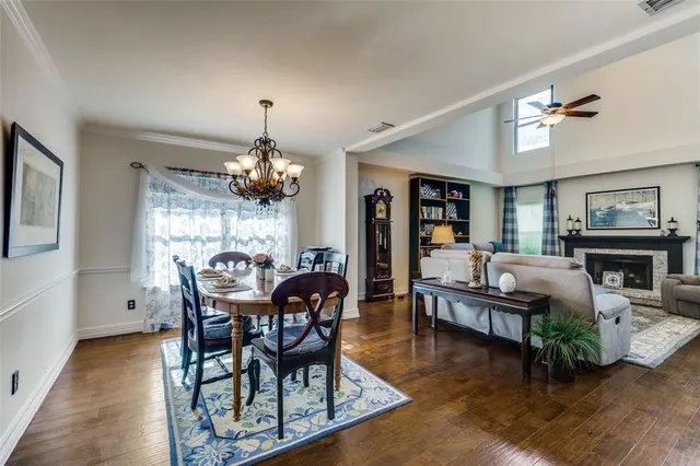 a view of a dining room with furniture and chandelier