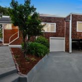 a view of a house with backyard and sitting area