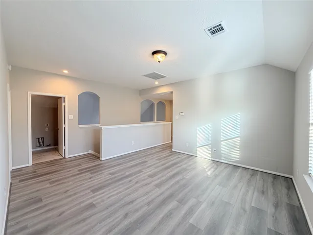 wooden floor in an empty room with a window