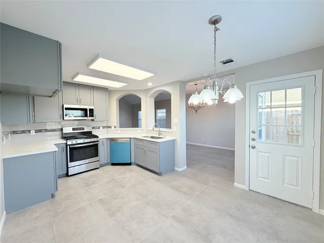 a spacious bathroom with a granite countertop sink and a mirror