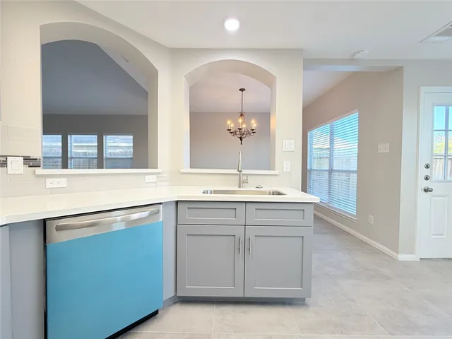 a kitchen with stainless steel appliances granite countertop a sink stove and microwave