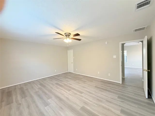 a spacious bathroom with a granite countertop sink mirror and bathtub