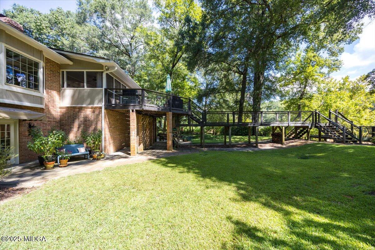 11 River Trace Macon, GA 31210 - Photo 17 of 61 a front view of a house with a garden and trees