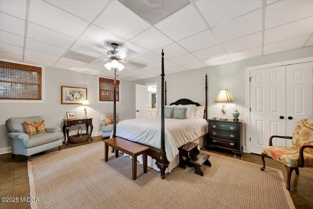 11 River Trace Macon, GA 31210 - Photo 49 of 61 a spacious bedroom with a bed a couch and a chandelier