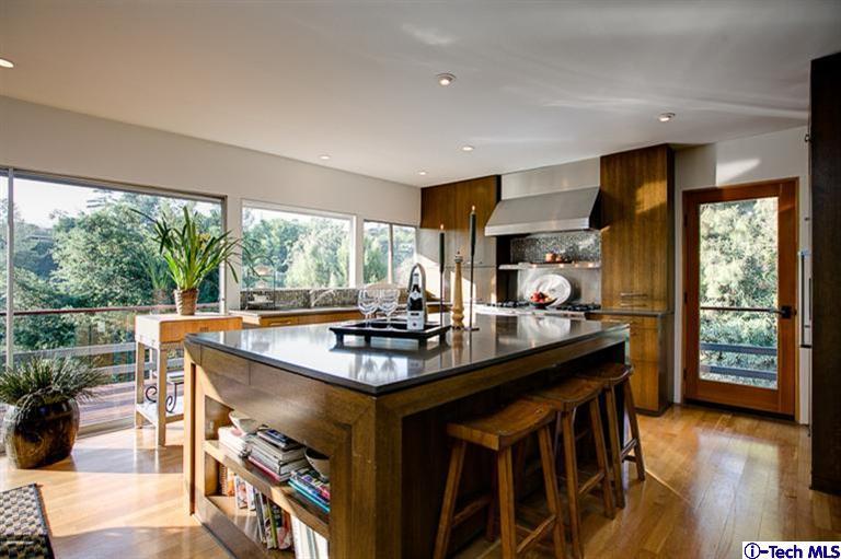 385 Manford Way Pasadena, CA 91105 - Photo 11 of 44 a table and chairs in a room with kitchen view